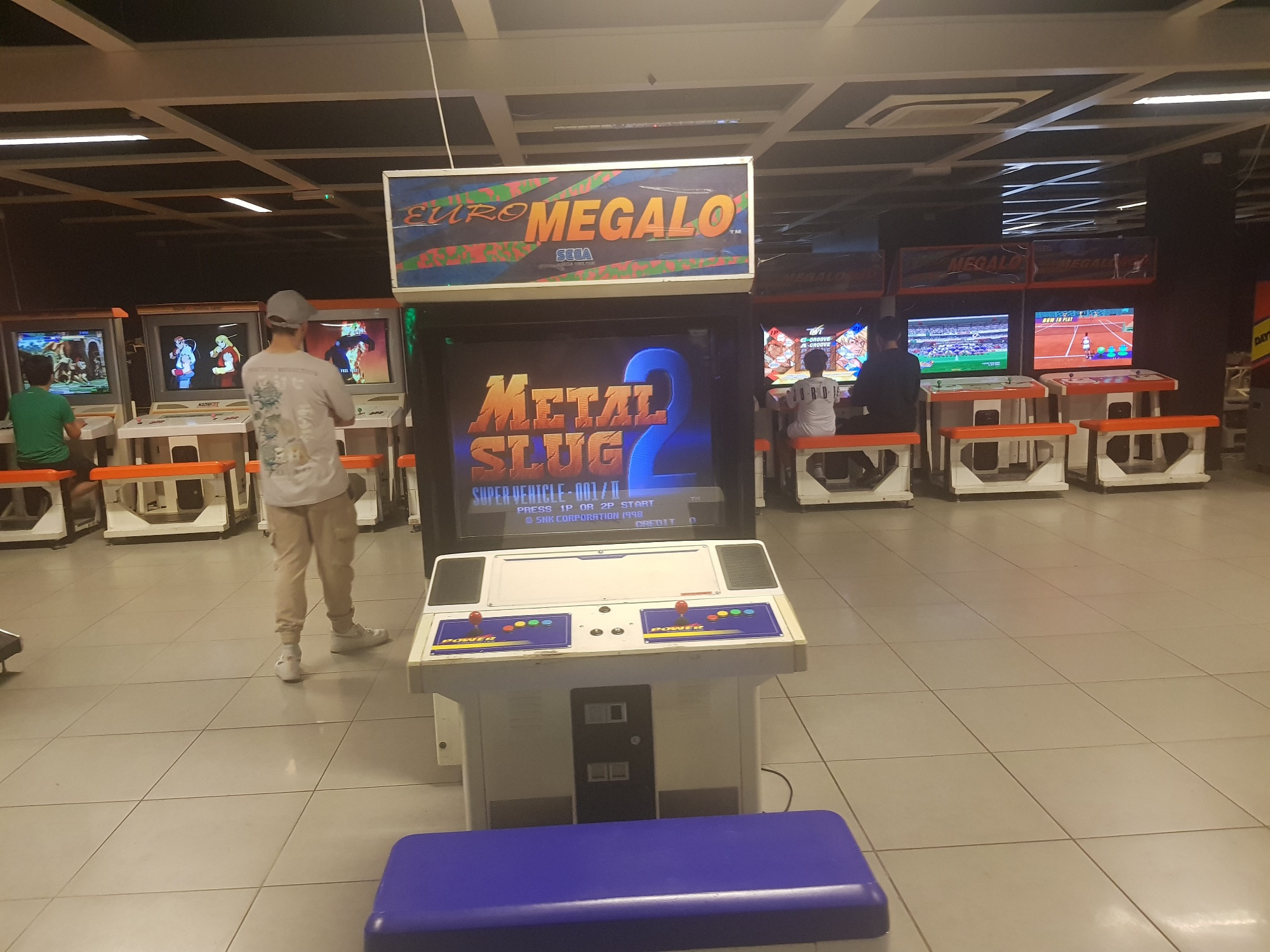 A four-slot Neo Geo cabinet with Metal Slug 1-3 and X