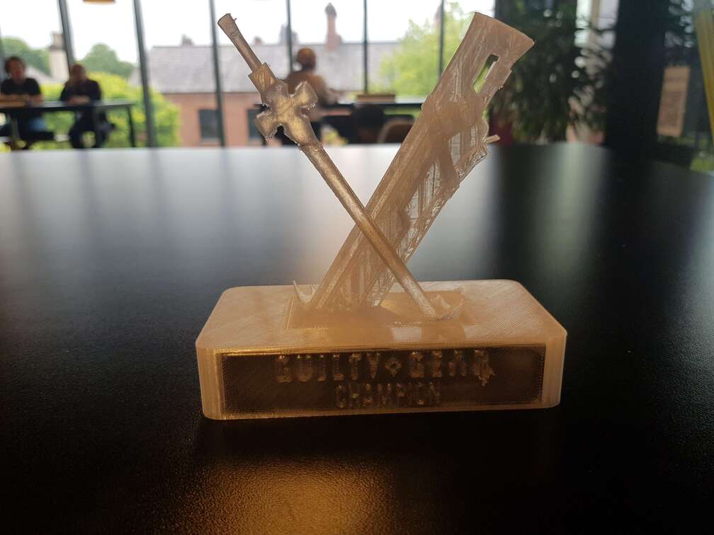The 1st place trophy for GGST at Q-Con 2025. It&rsquo;s 3D printed and depicts Sol and Ky&rsquo;s weapons, Fireseal and Thunderseal.